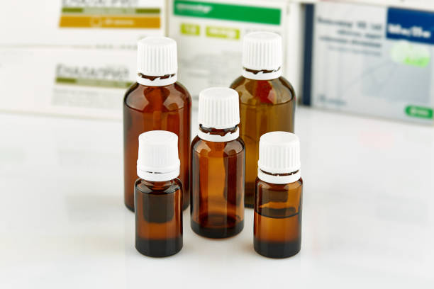 istock Five small brown medicine phials with pills packs on background 1130631532
