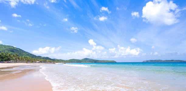 istock Beautiful amazing gold colored sandy beach with soft waves isolated with sunny blue sky. Concept of tropical calm tourism idea, copy space, close up 1130632438