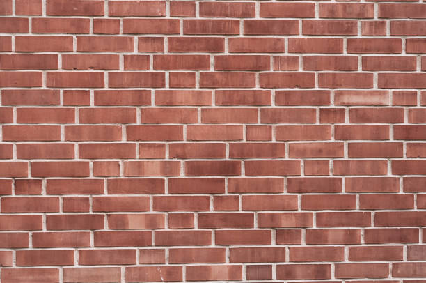 istock Background from a wall with red bricks of different shades and jointing 1130633040