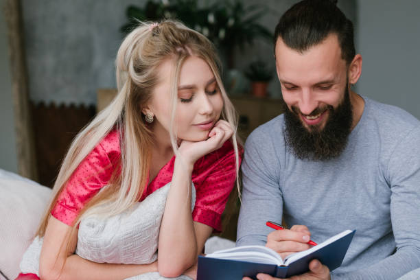 istock newlyweds honeymoon plan couple make notes 1130633903