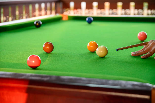 istock Man's hand playing snooker in bar with snooker ball 1130636341