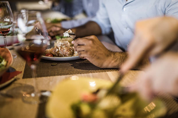 istock Close up of unrecognizable man eating dinner in a restaurant. 1130637837