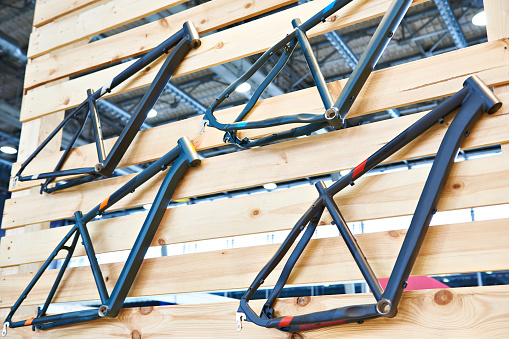 Bicycle frames on wooden wall in store