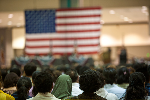 Los Angeles, California, USA - June 22, 2007: Immigrants of many ethnic backgrounds appear at a swearing in ceremony for US citizenship. Photo taken at the US Court's public citizenship ceremony at the LA Convention Center.