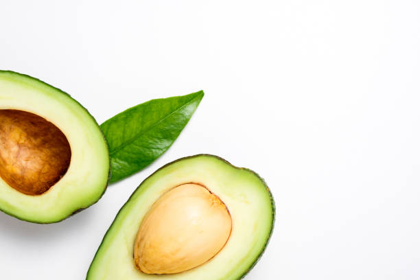 istock Avocado on white background. Tropical abstract background with avocado and leaf. Flat lay. Top view 1130640169