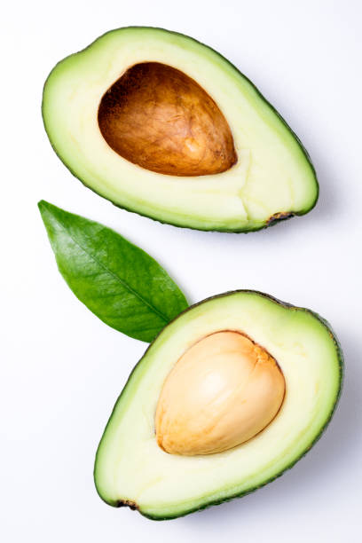 istock Avocado on white background. Tropical abstract background with avocado and leaf. Flat lay 1130640225