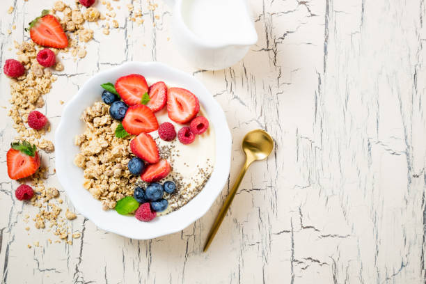 istock Granola for breakfast with berries and yoghurt. Cereal oatmeal or  muesli with strawberries, blueberries and raspberries. Concept dieting, healthy food and eating 1130640407