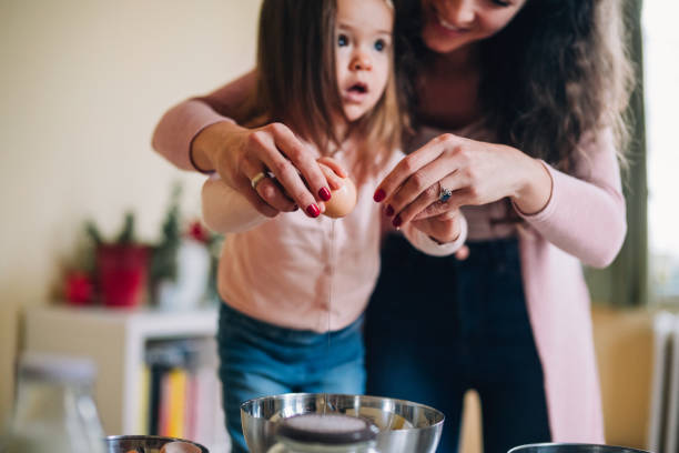 istock Happy mother and daughter in kitchen 1130640422