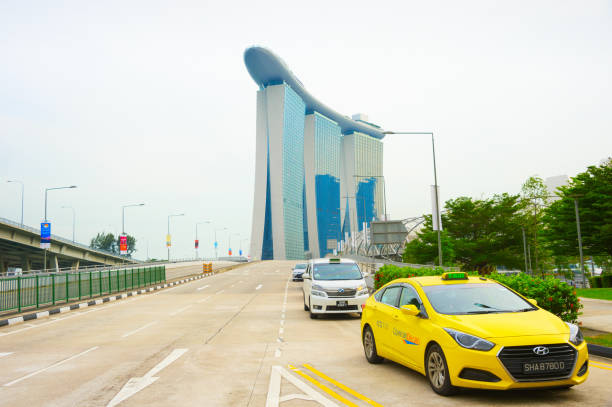 SINGAPORE - JANUARY 14, 2017: Taxi cabs at Singapore highway, Marina Bay Sands Resort building in background
