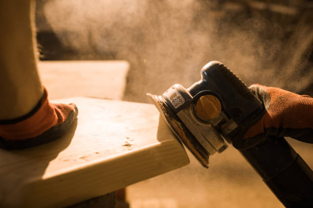 istock Close up of worker using sander on a piece of wood in carpentry workshop. 1130645955