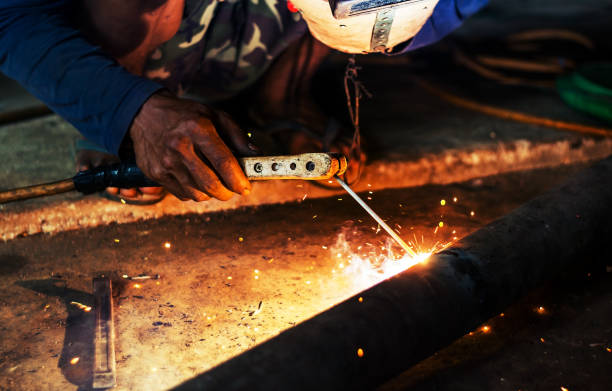 istock Hand of man welding steel blurred on black background 1130646977