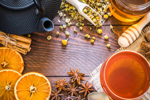 istock Tea time: cup of tea, chamomile, cinnamon sticks, anise, dried orange frame 1130648851