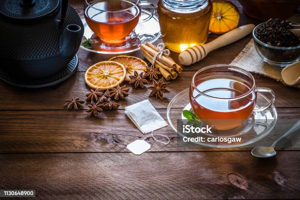 Tea Time Cup Of Tea Cinnamon Sticks Anise Dried Orange On Wooden Table Stock Photo - Download Image Now