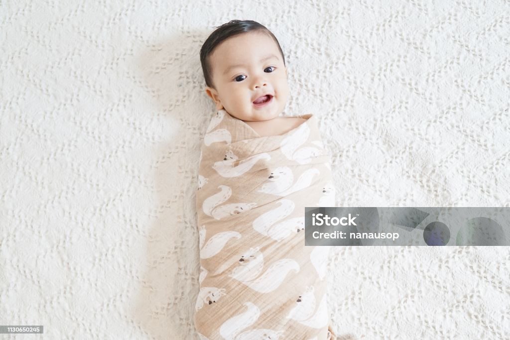 Swaddle A cute asian baby being swaddled Baby Blanket Stock Photo
