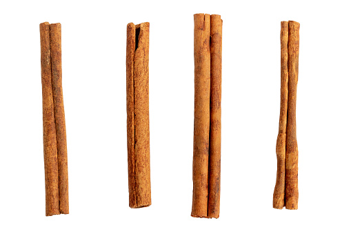 Four cinnamon sticks isolated on white background closeup. Top view.