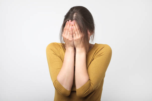 istock Girl in yellow clothes covered her face. 1130652014