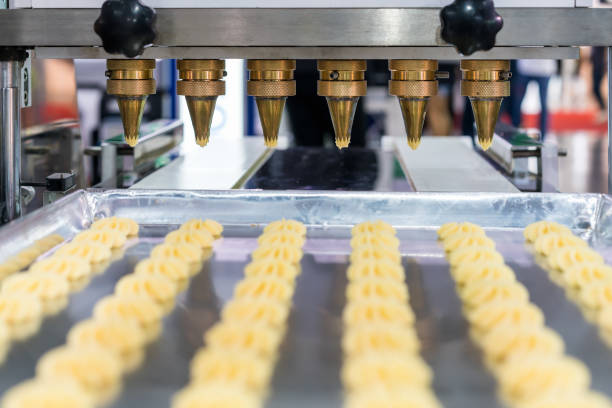 istock close up dough or cream and nozzle discharge of automatic biscuit or sweets making machine in production line for high technology of industrial food manufacturing 1130652378