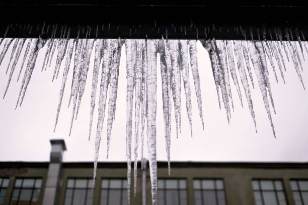 istock Long icicles fall from the roof on winter and early spring. 1130657531