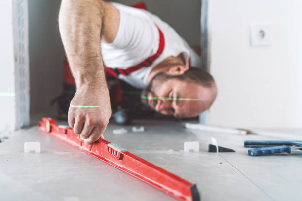 istock Tiler measuring and leveling the tiled floor 1130660602