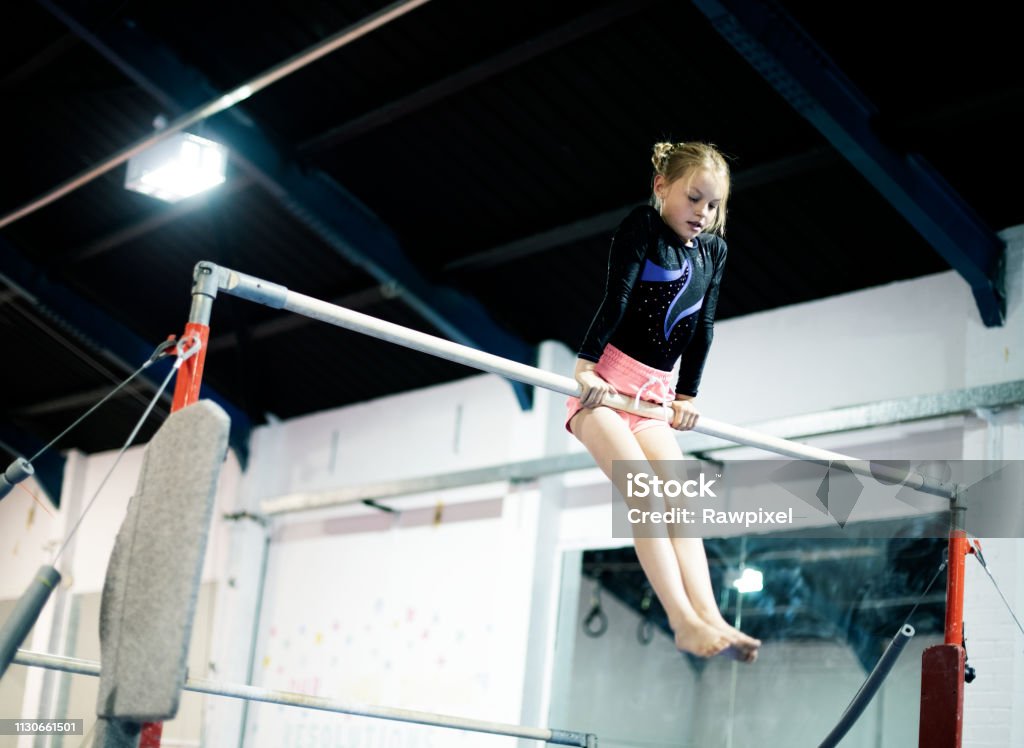 Young gymnast on a horizontal bar Gymnastics Stock Photo
