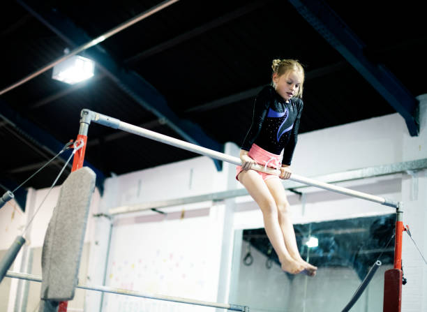Young gymnast on a horizontal bar Young gymnast on a horizontal bar horizontal bar stock pictures, royalty-free photos & images