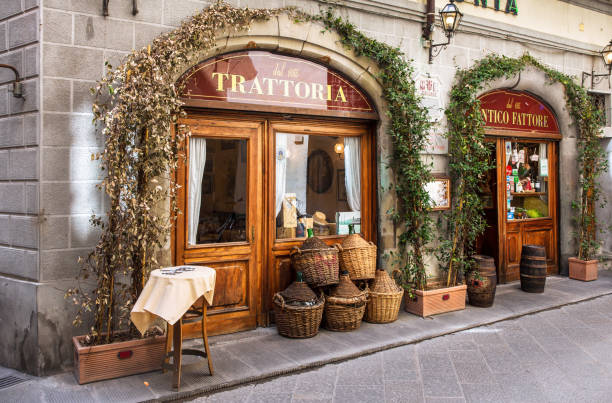 Traditional trattoria in Florence Florence, Italy - April 08, 2018: Traditional trattoria on narrow street in Florence, Tuscany Italy brick cafe stock pictures, royalty-free photos & images