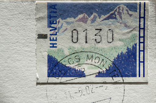 old stamp from Switzerland and postmark on a postcard