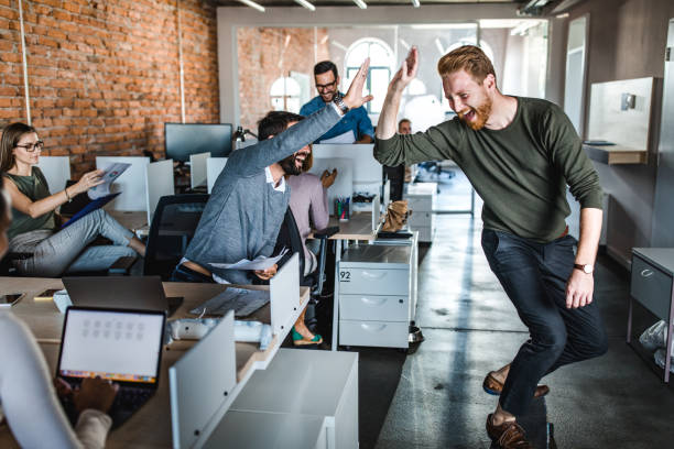 istock Cheerful businessmen having fun while giving each other high-five at corporate office. 1130662693