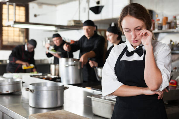 istock Tired and upset waitress in kitchen of restaurant 1130663225
