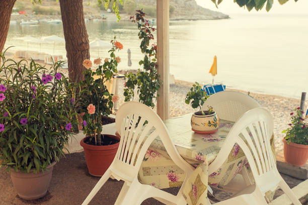 istock Empty table and chairs by the sea - Lovely scene in Haraki, Greece 1130664951