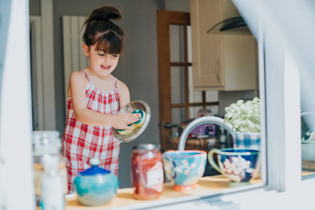 Little girl doing the dishes