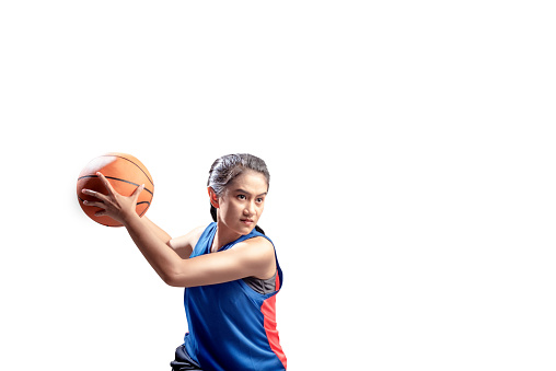 Portrait of asian girl basketball player defending the ball from opponent isolated over white background
