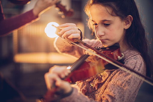 One young girl playing violin.