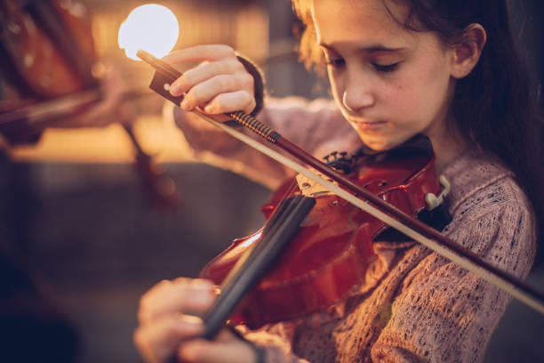 istock Cute girl playing violin 1130666601