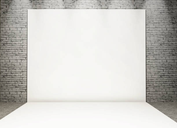 istock 3D white photo back drop in a grunge brick interior 1130666899