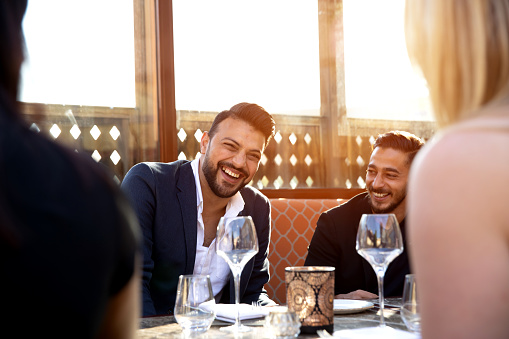 Group of multi ethnic arab friends lunch in a restaurant in Dubai