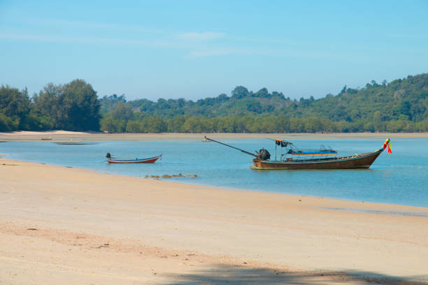 istock fishing boat on the beach in thailand 1130669981