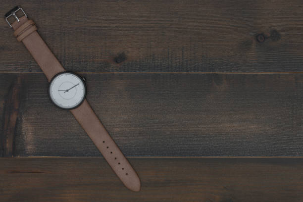 wristwatch on wooden table with free text space