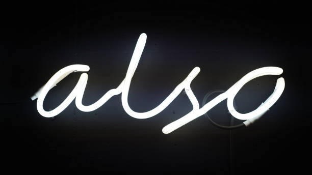 istock Glowing neon sign on the wall. Word 'also' shape 1130673709