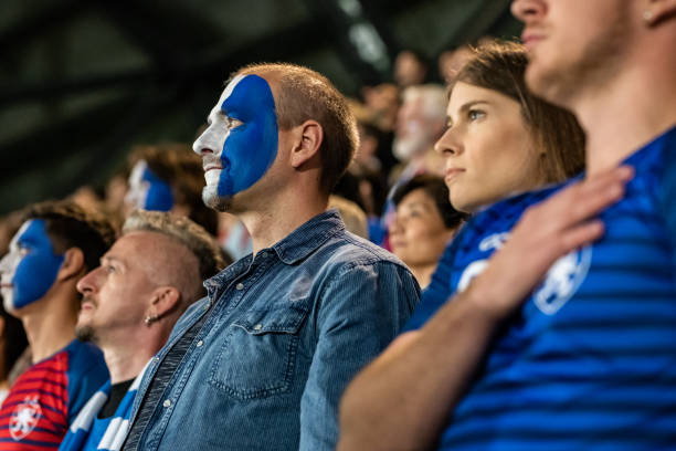 istock Spectators singing national anthem in stadium 1130673781