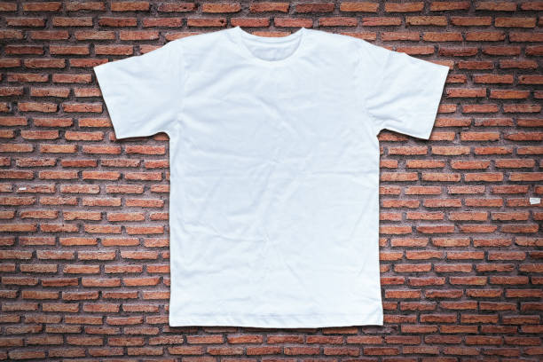istock White t-shirt on brick wall background. 1130675275