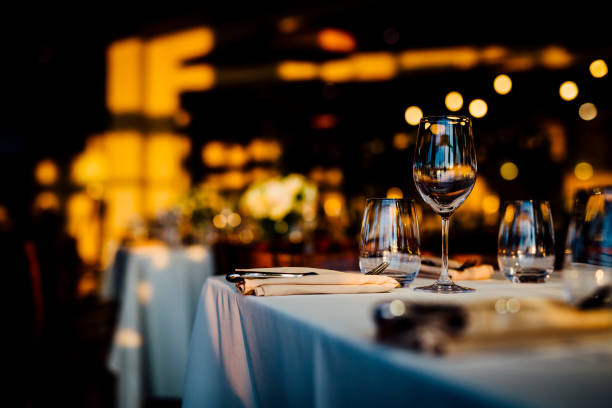 istock Luxury table settings for fine dining with and glassware, beautiful blurred  background. For events, weddings. 1130675505
