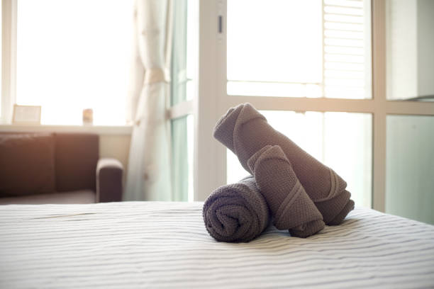 istock Clean stack of towels in hotel bedroom. 1130676437