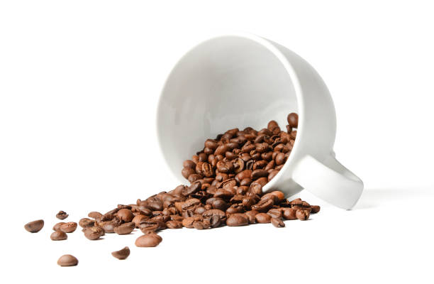 istock Coffee beans scattered from a fallen cup. White isolated background. 1130676707