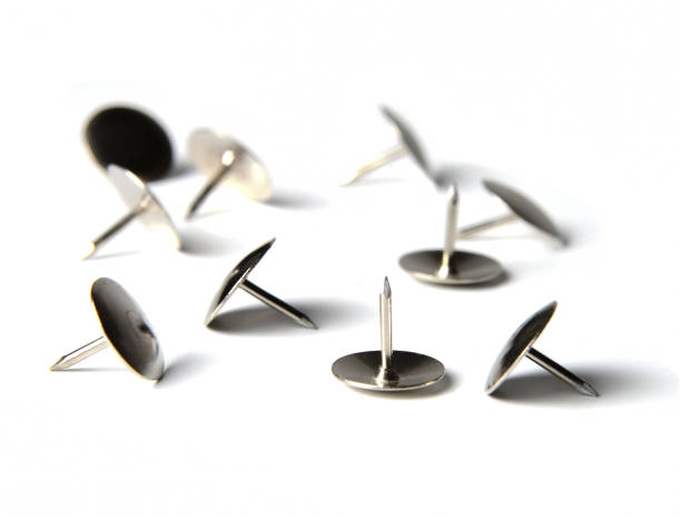 istock Several metal pins are in a chaotic manner on a white isolated background. Close-up. 1130676711