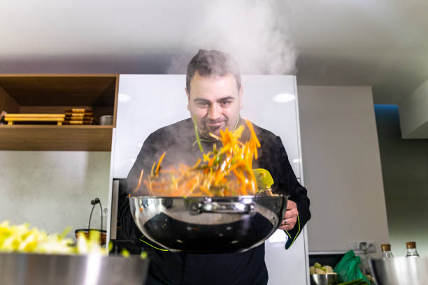 istock Chef cooking fresh vegetables  on a wok 1130678570