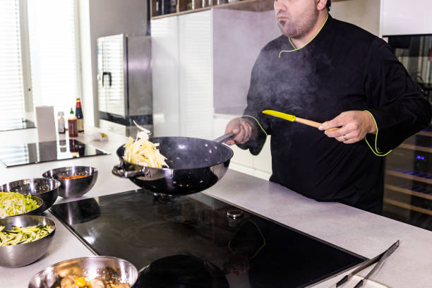 istock Chef cooking fresh vegetables  on a wok 1130678586