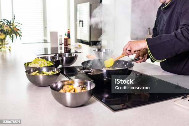 Chef Cooking Fresh Vegetables On A Wok Stock Photo - Download Image Now - Adult, Asia, Backgrounds