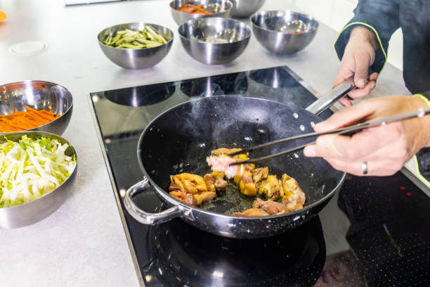istock Chef frying chicken to make a wok 1130678592