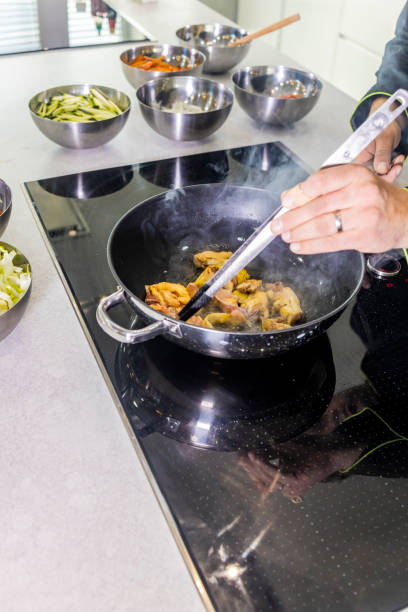 istock Chef frying chicken to make a wok 1130678597